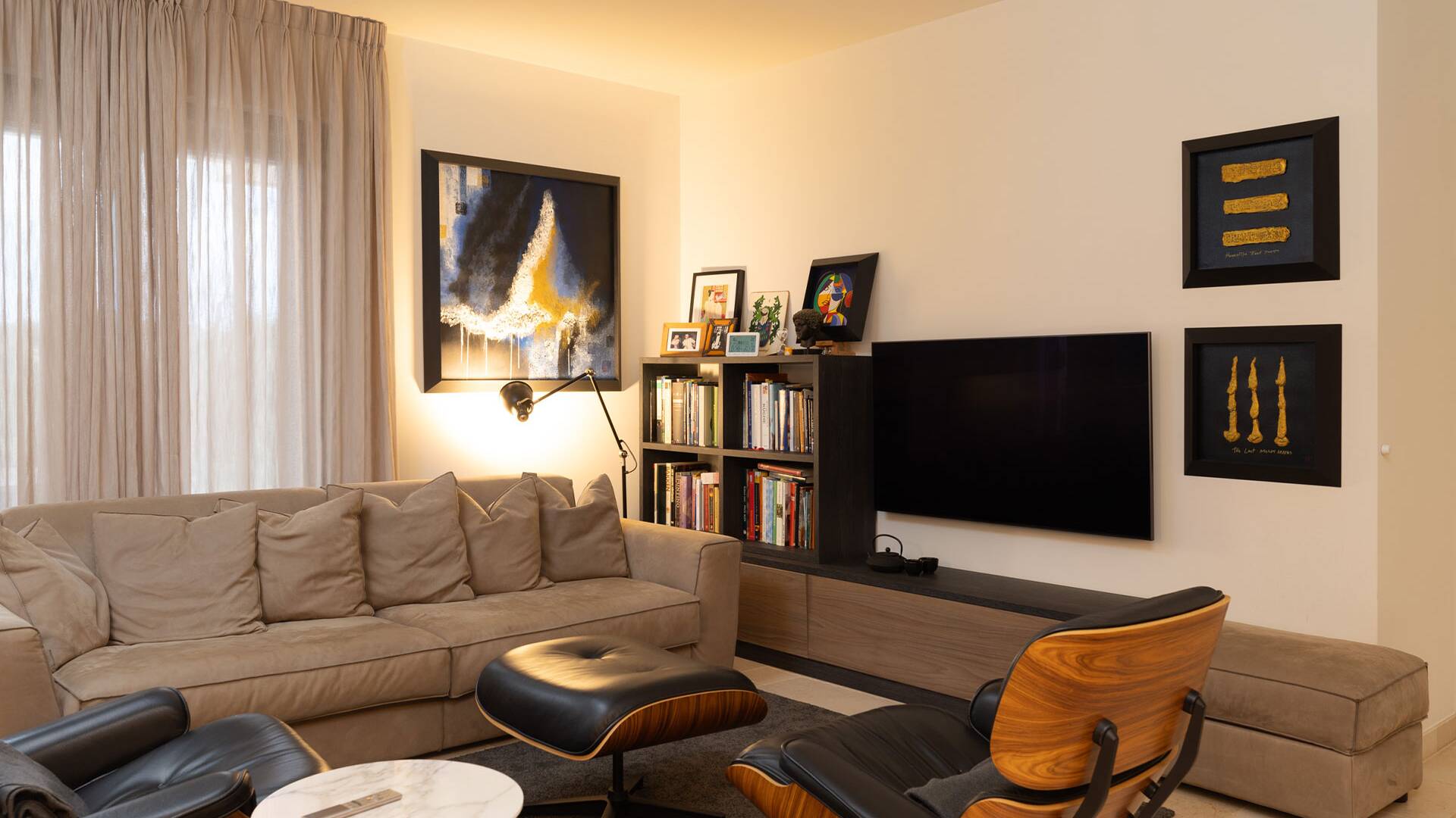 one of the three living rooms with TV and comfortable sofa