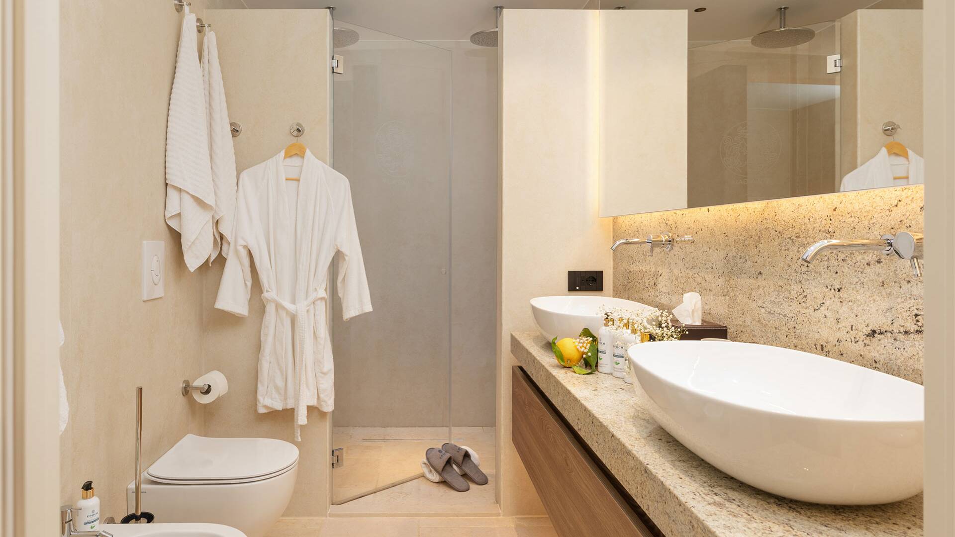 en suite bathroom with walk-in shower and double basin