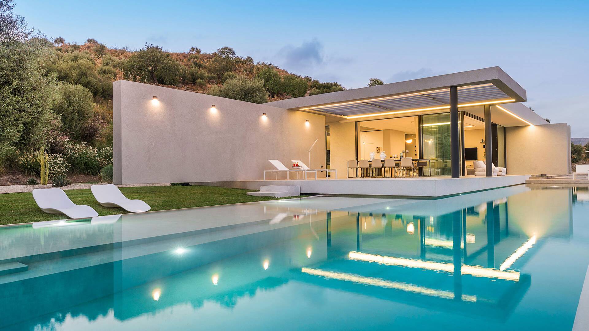 infinity swimming pool with sun loungers