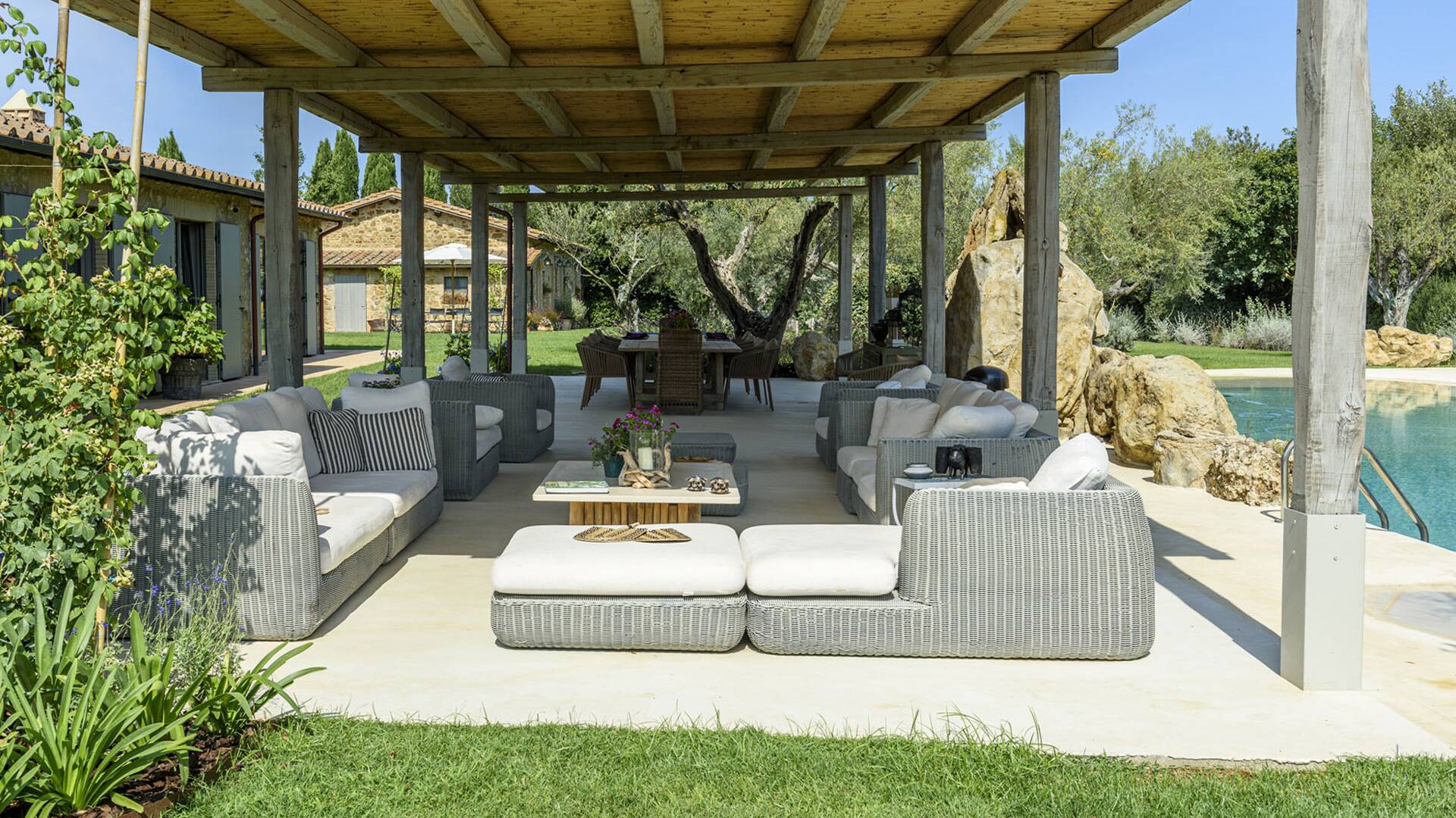 patio with lounge area in front of the pool 