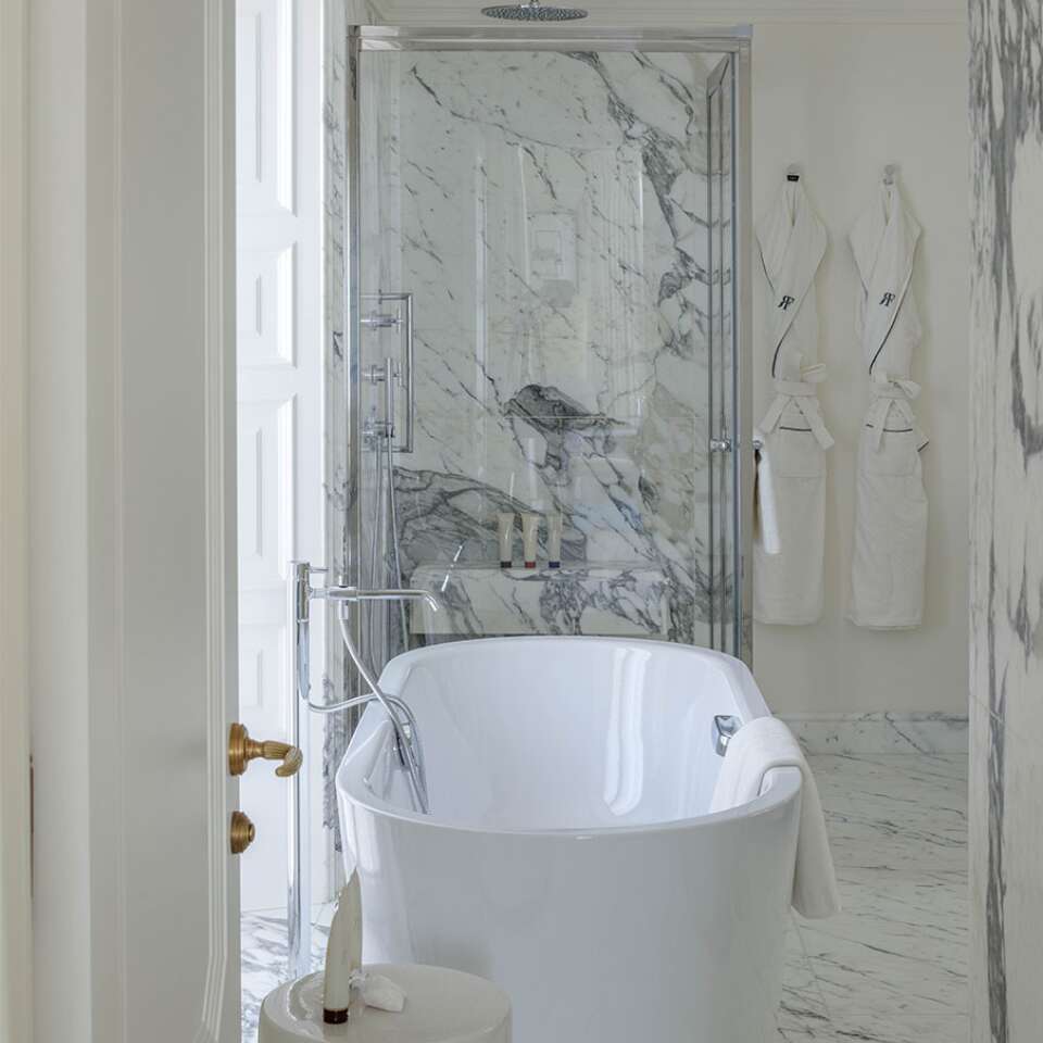 en suite bathroom with bathtub and shower