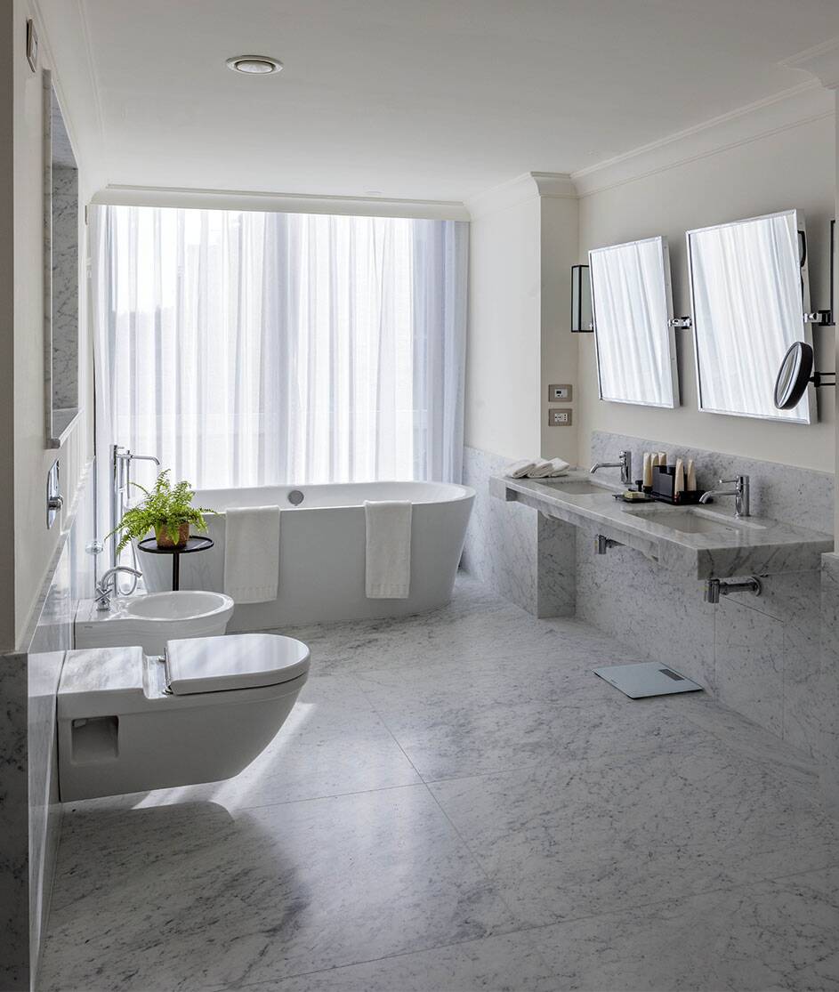 en suite bathroom with bathtub and walk-in shower