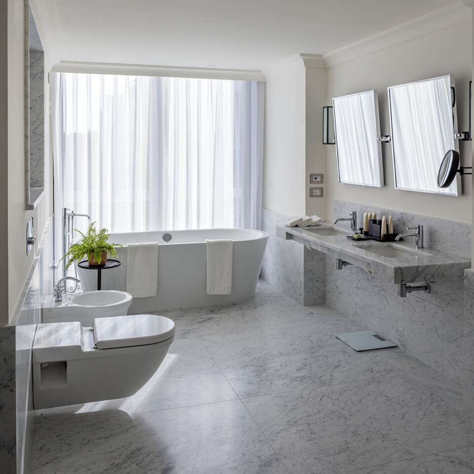 en suite bathroom with bathtub and walk-in shower