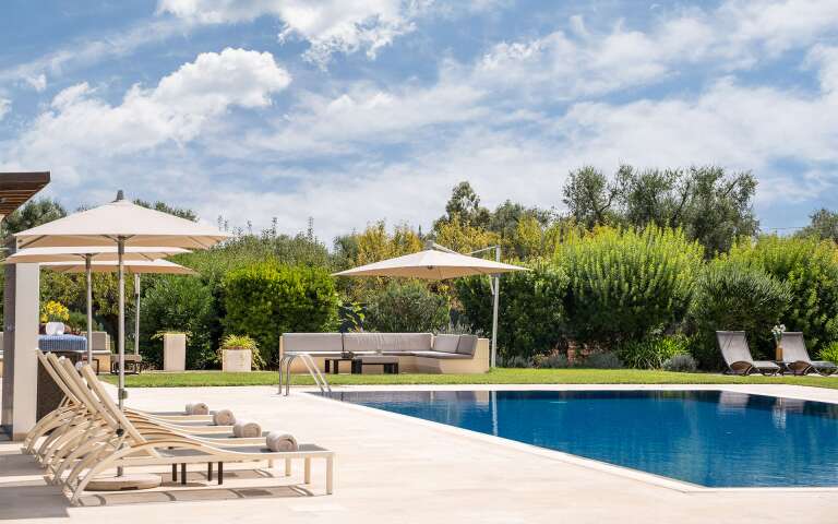 private swimming pool with equipped sunbathing area