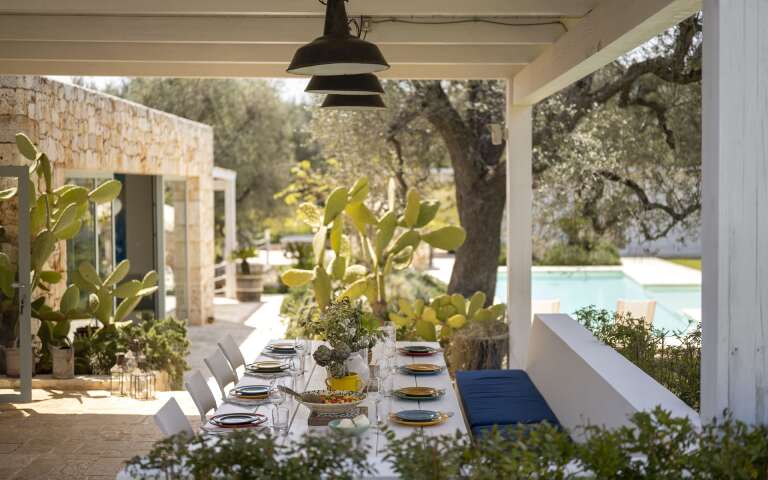 covered pergola with dining table