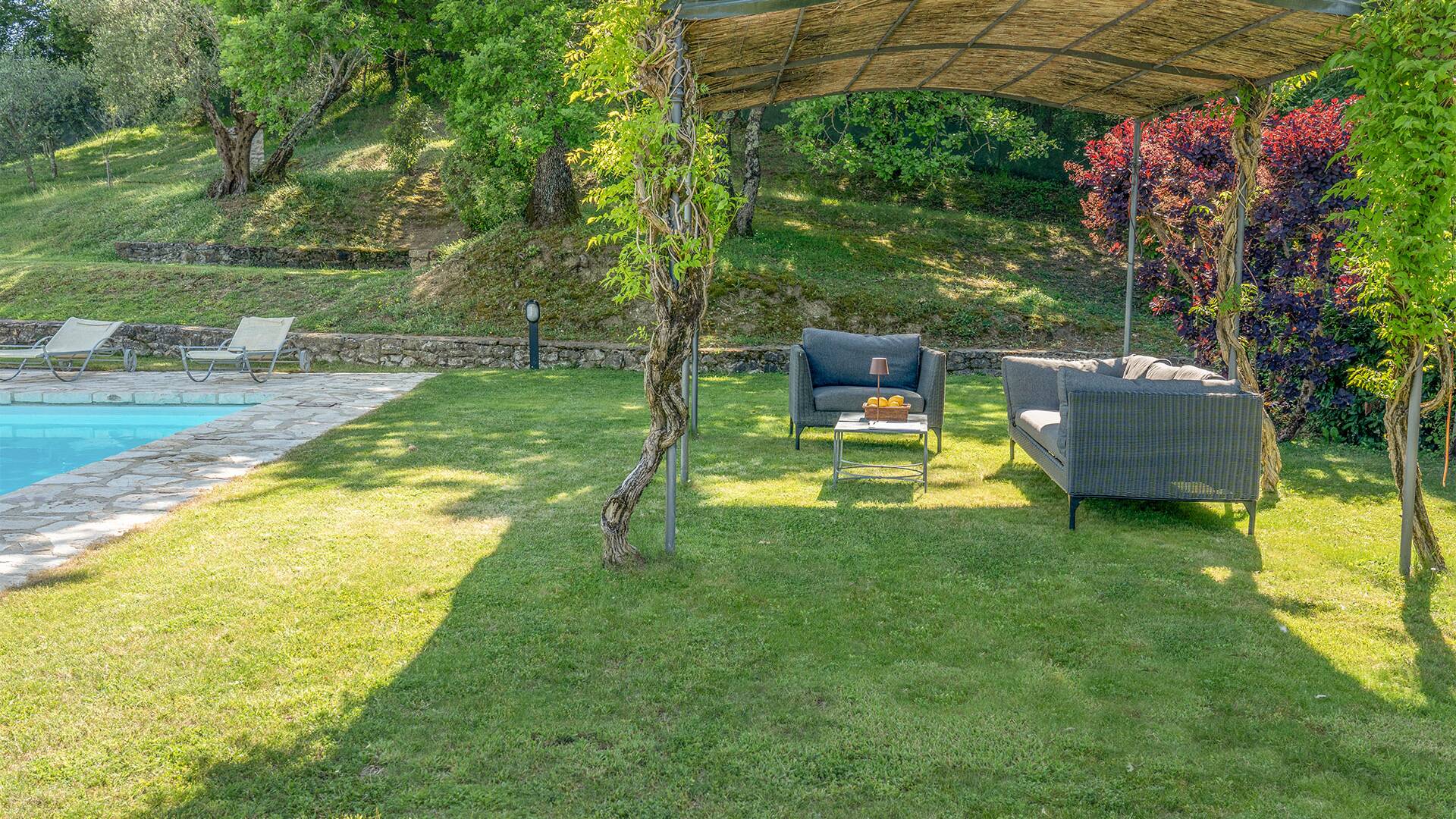 covered sitting area by the private pool