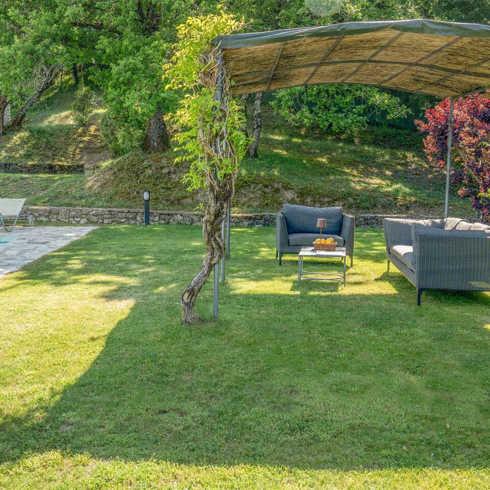 covered sitting area by the private pool