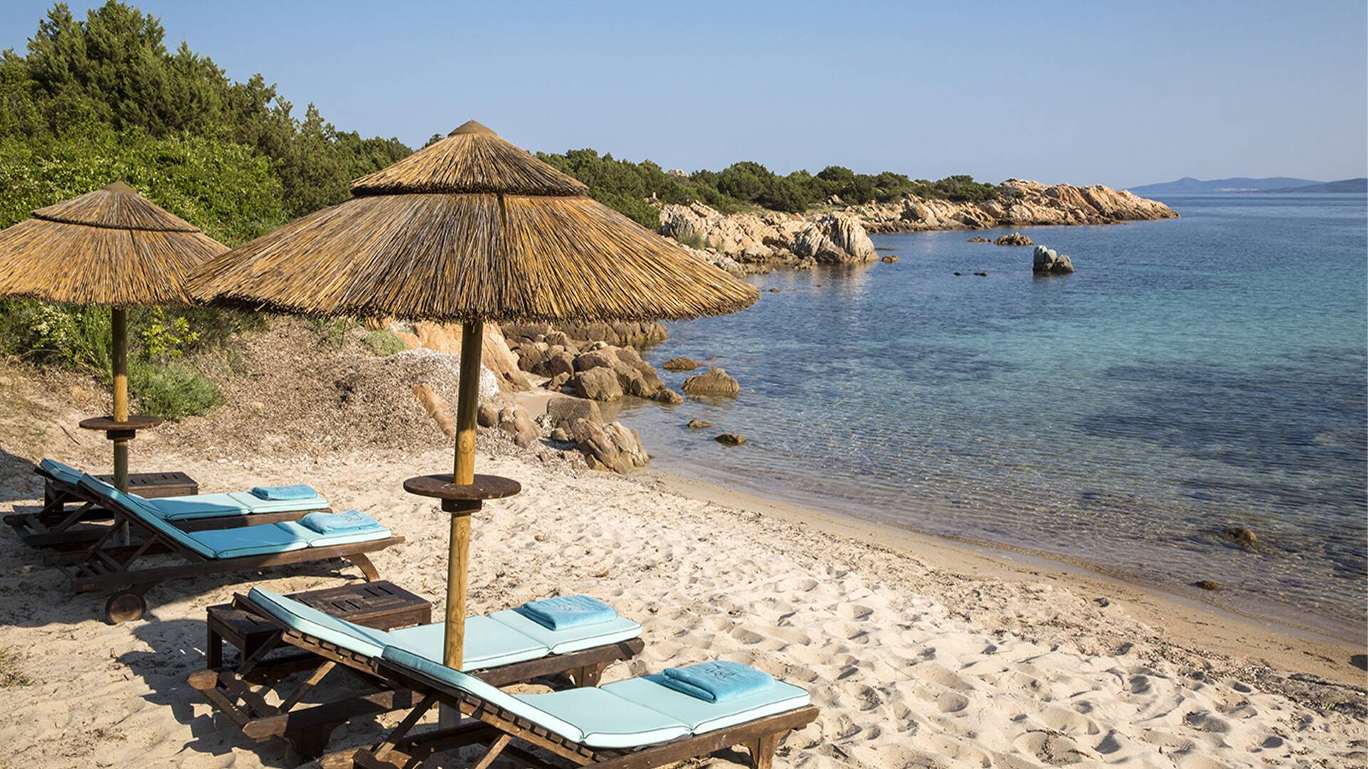 beach with sunbeds and umbrellas