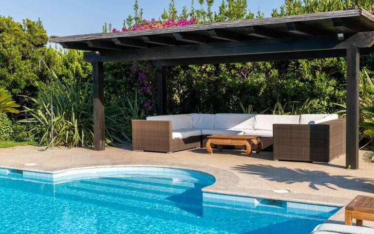 covered sitting area by the pool