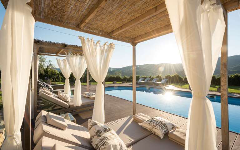 private pool with sunbathing area and gazebo