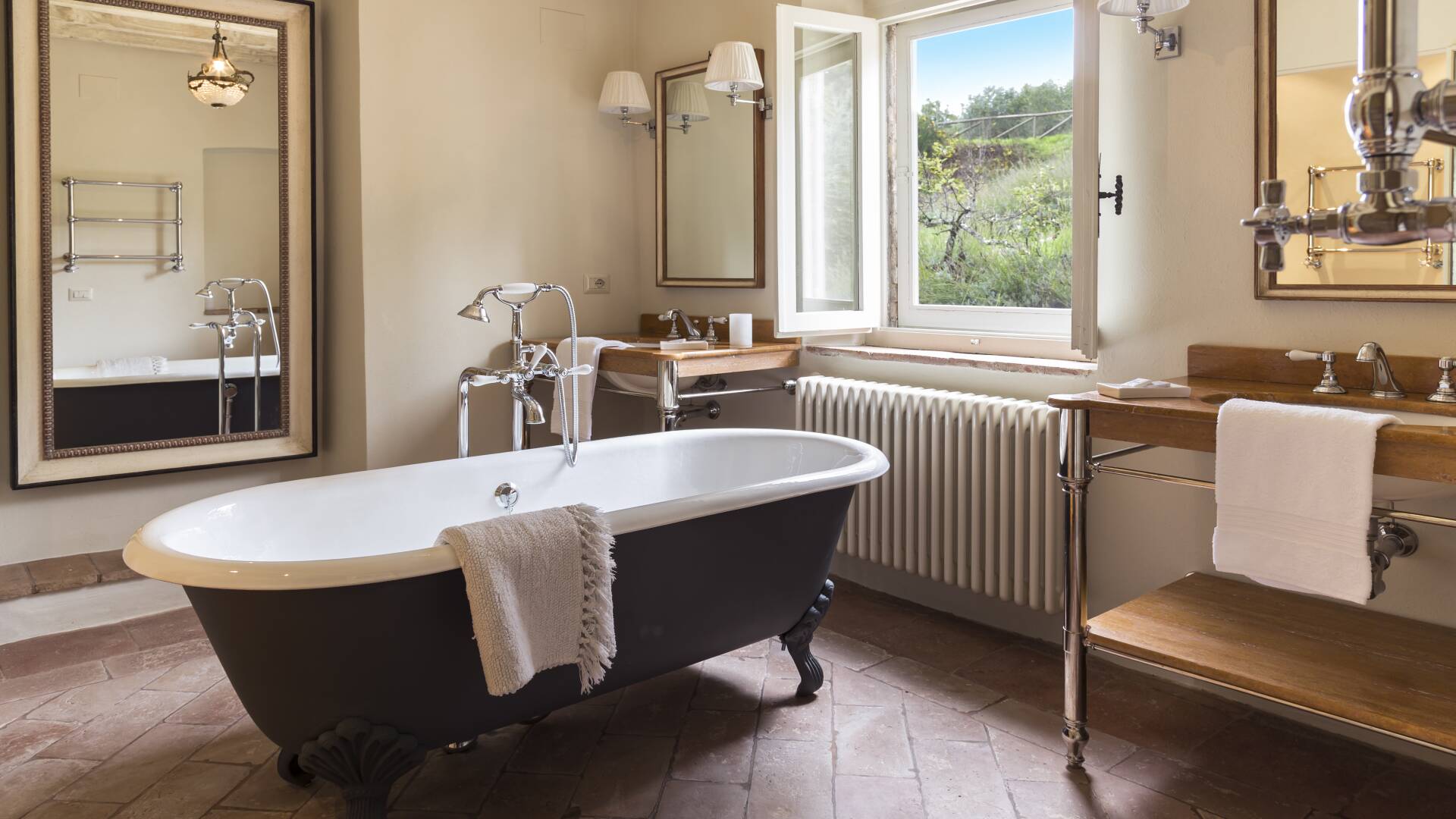 en suite bathroom with bath tub and countryside view
