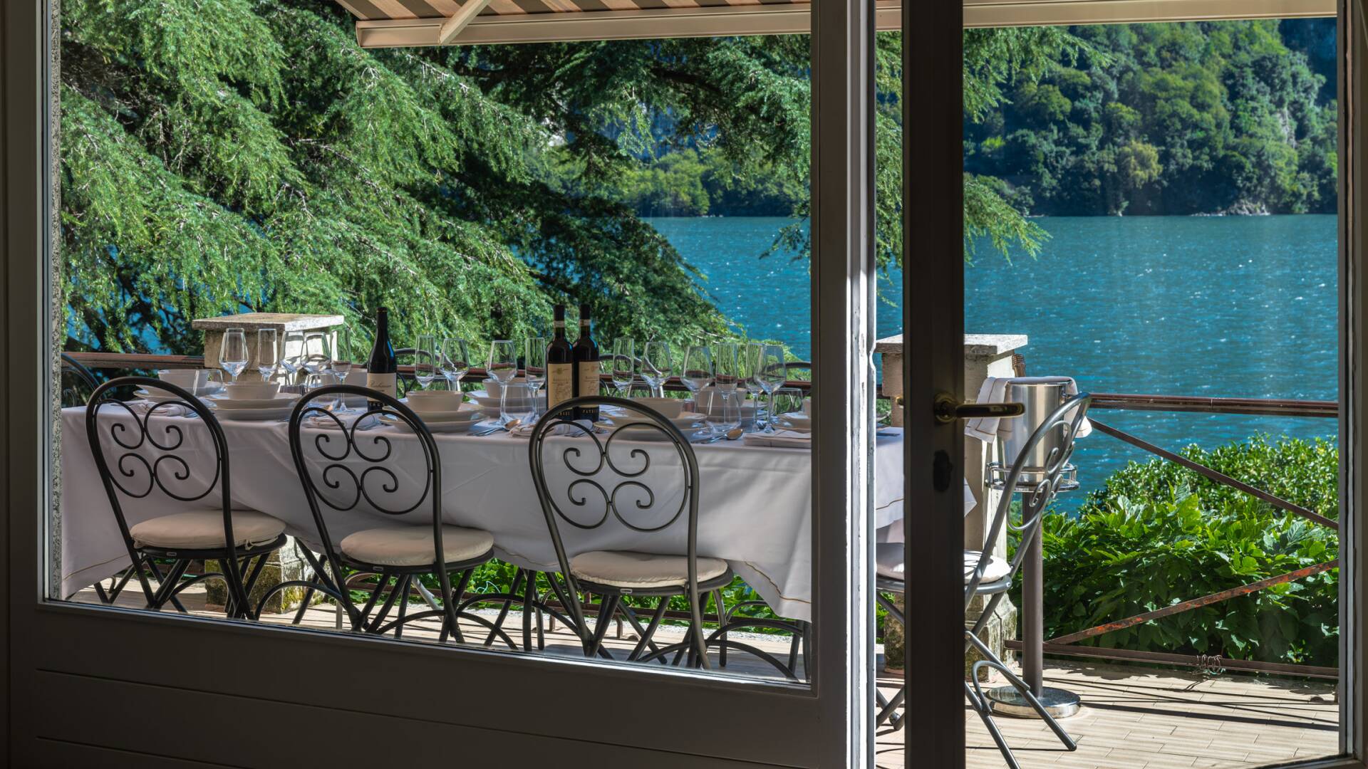 covered al fresco dining table with lake view