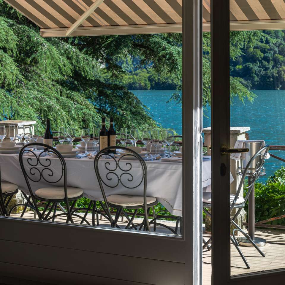 covered al fresco dining table with lake view