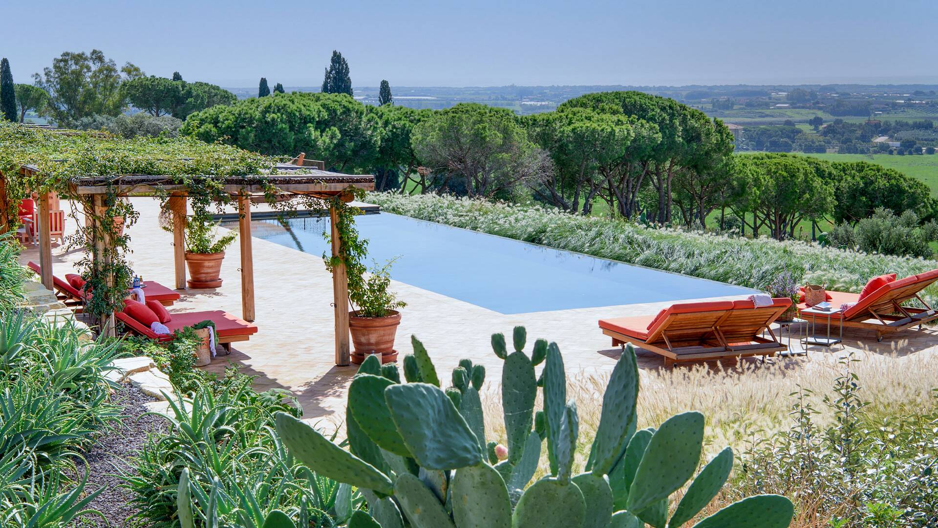 sunbathing area by infinity swimming pool