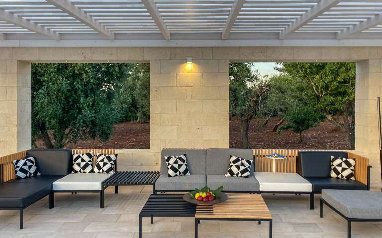 covered sitting area by the pool