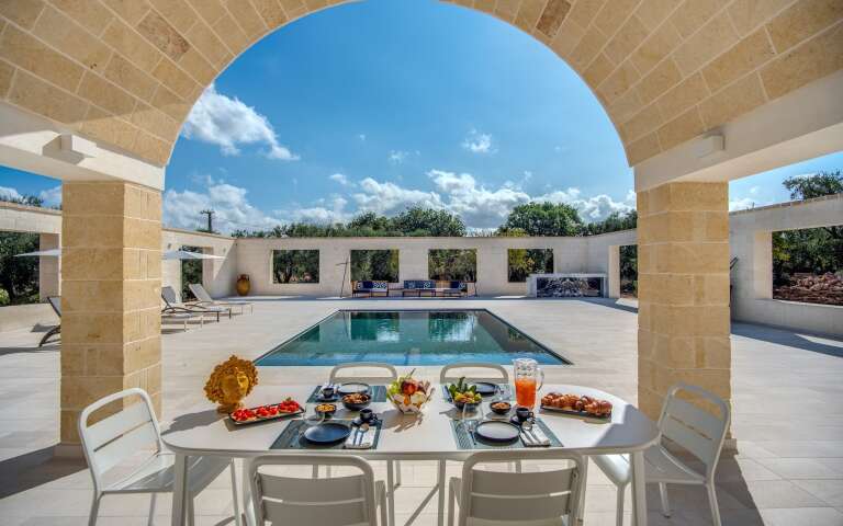 alfresco dining in front of swimming pool