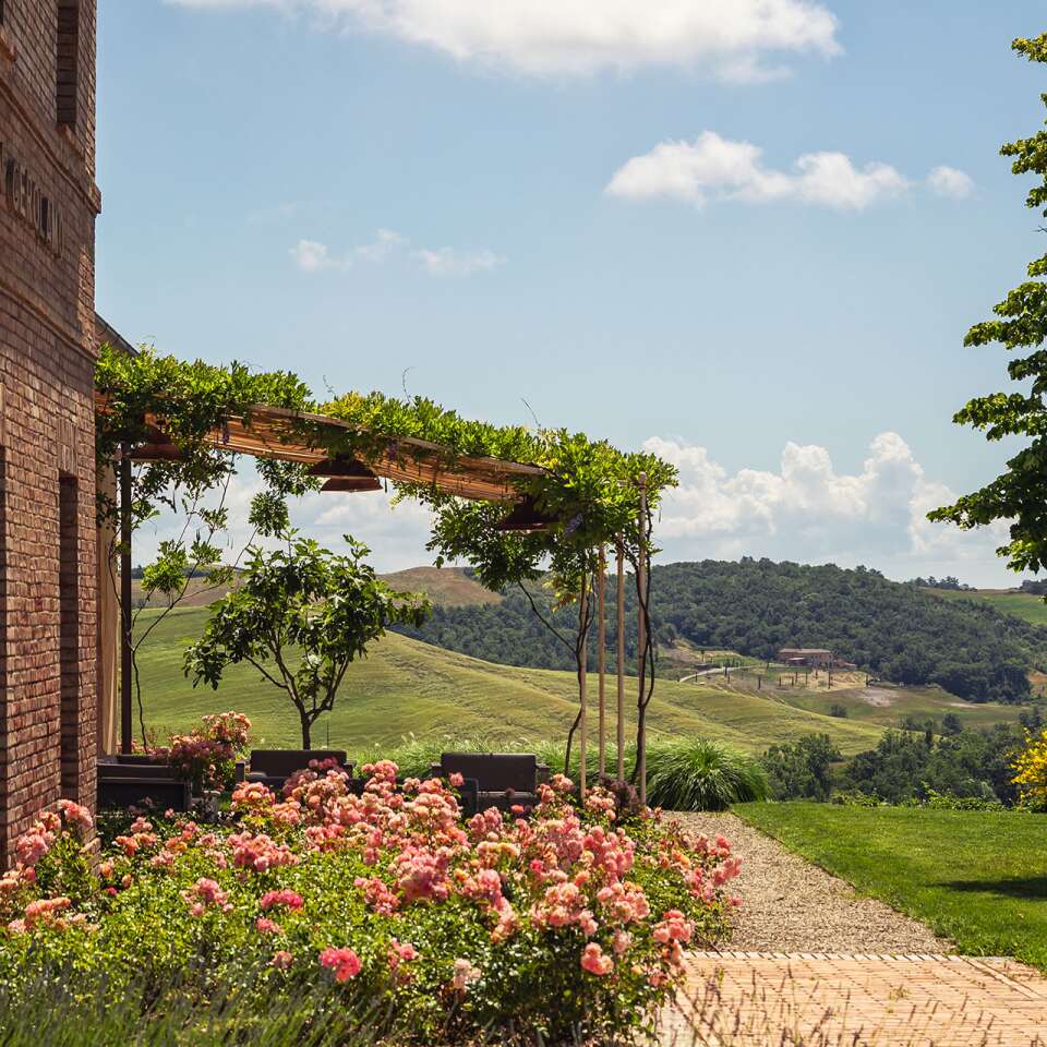 covered sitting area surrounded by Tuscan countryside
