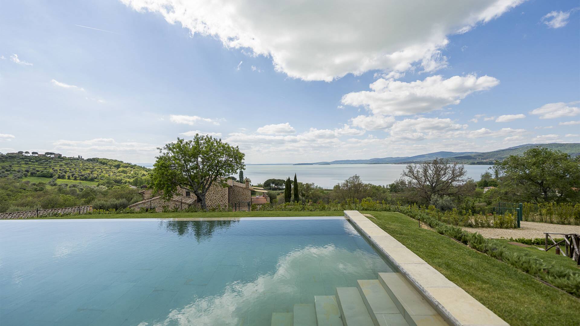 infinity swimming pool with lake view