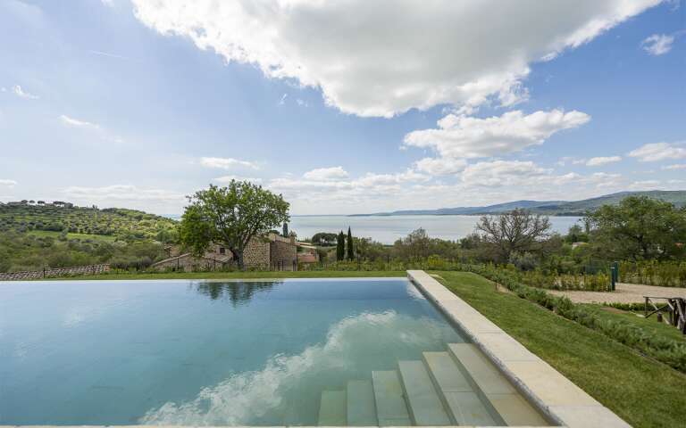 infinity swimming pool with lake view