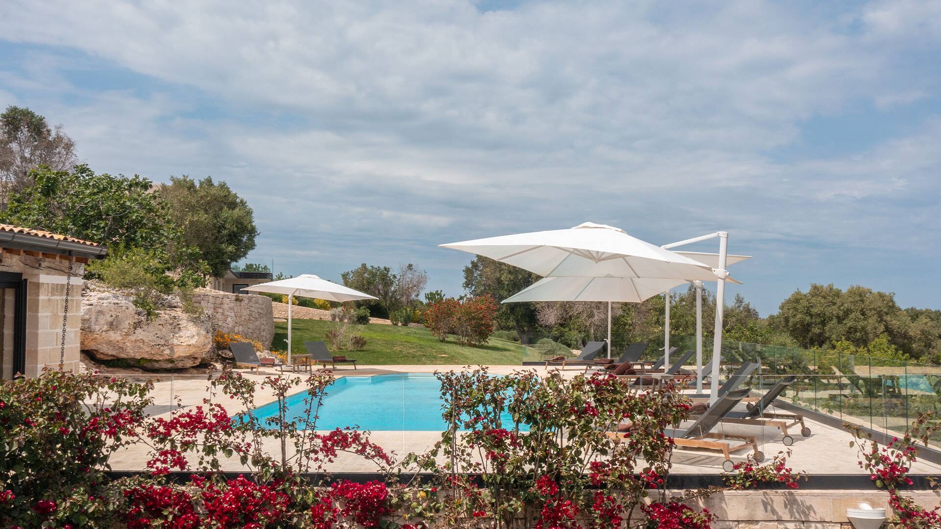 fully equipped sunbathing area with deckchairs and umbrellas
