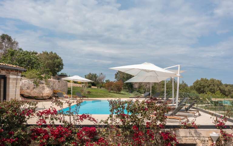 fully equipped sunbathing area with deckchairs and umbrellas