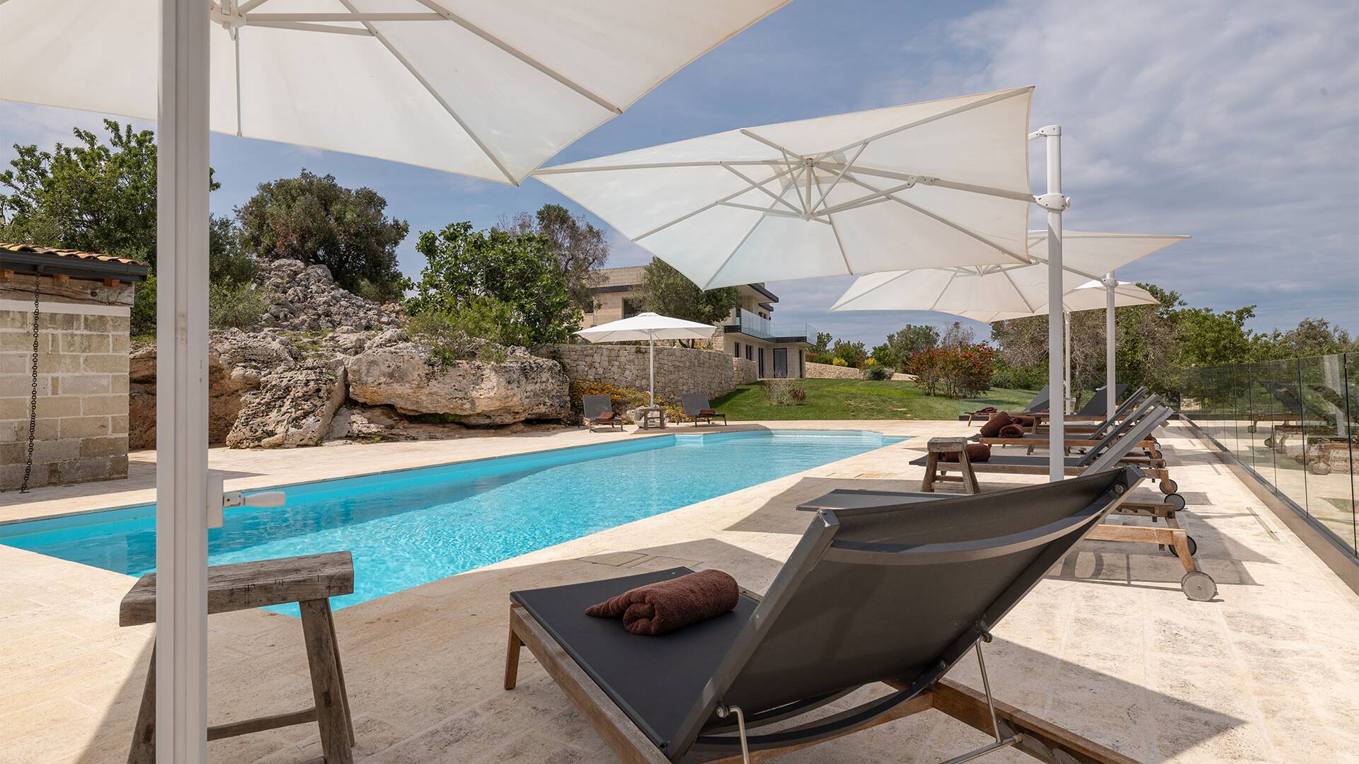 fully equipped sunbathing area with deckchairs and umbrellas