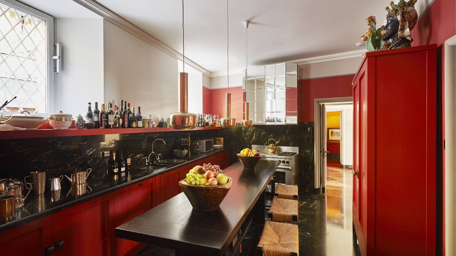 fully-equipped vibrant kitchen with top counter and stools