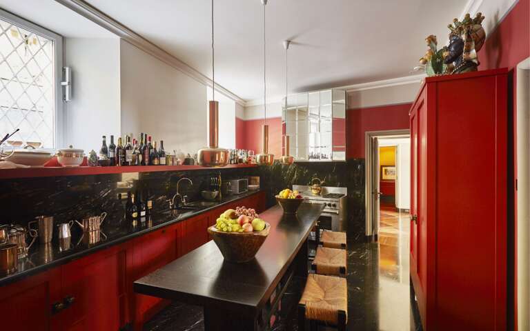 fully-equipped vibrant kitchen with top counter and stools