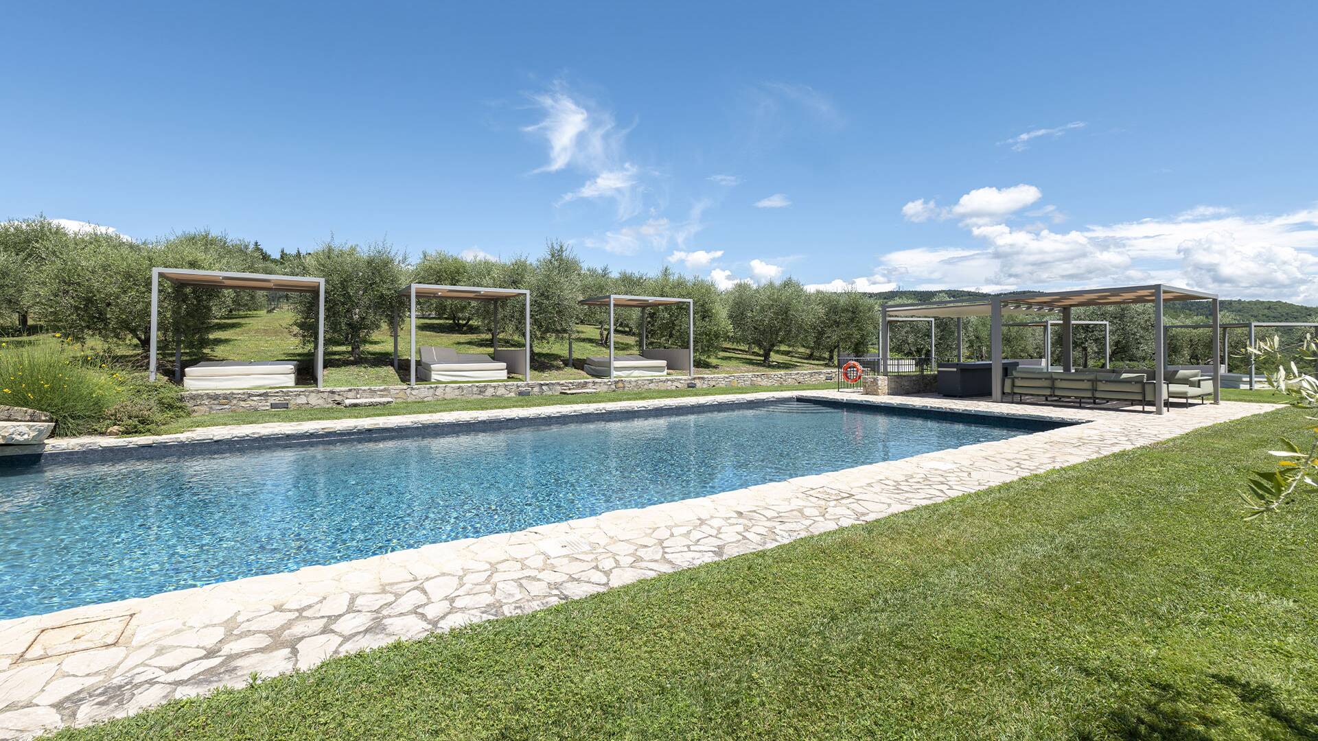 pool area with sun lounge and cabanas 