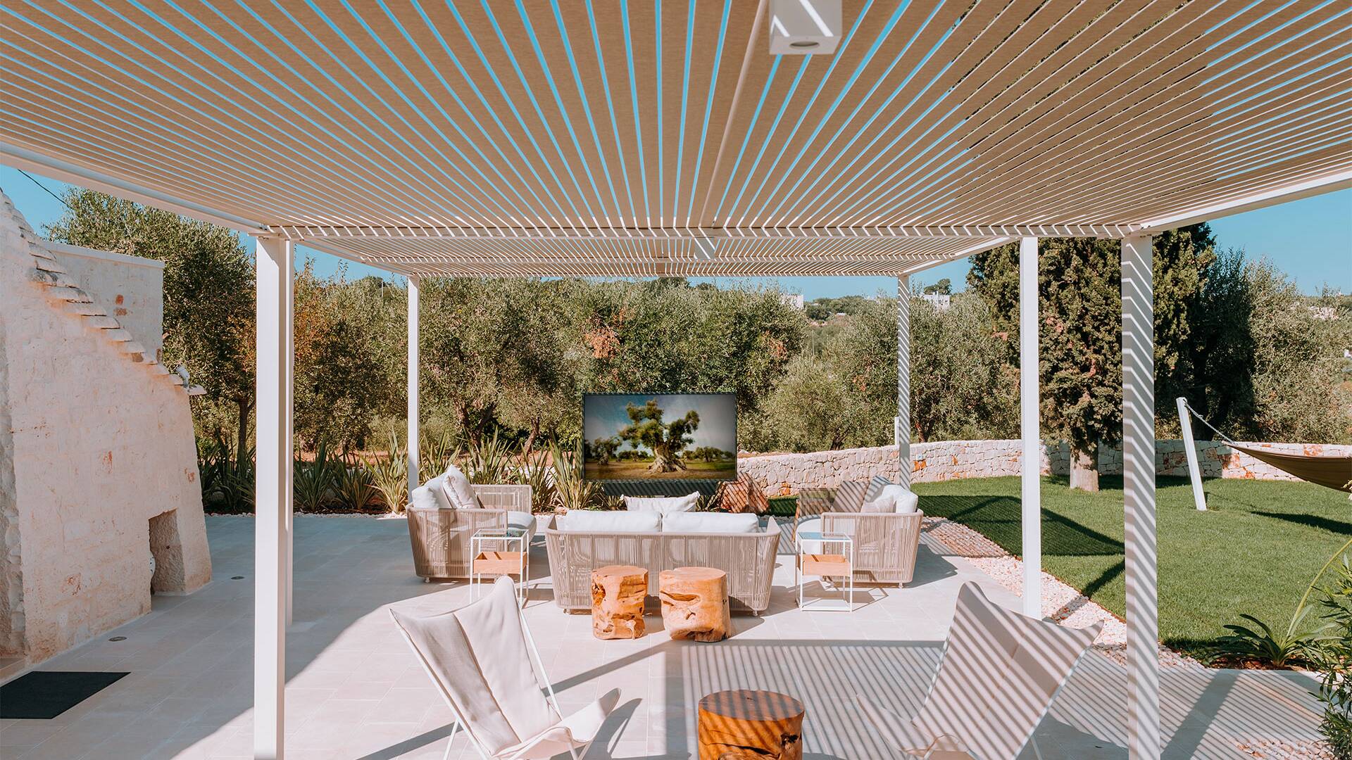 outdoor covered sitting area with TV