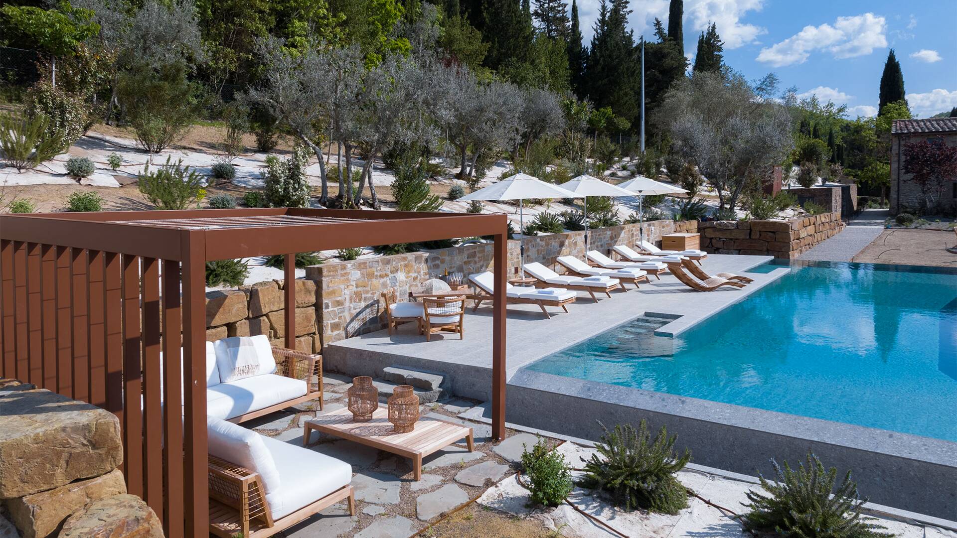 pool area equipped with umbrellas and sunbeds