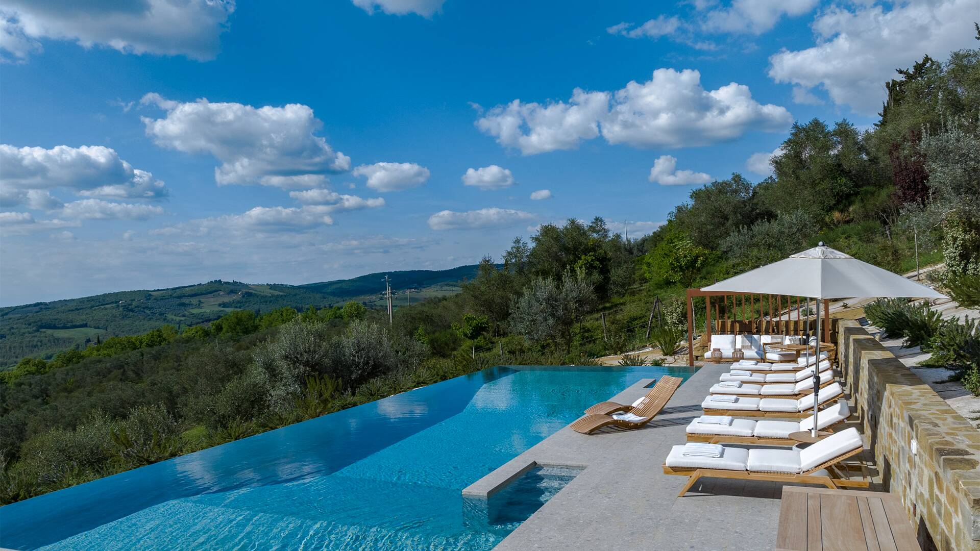 infinity swimming pool with sunbathing area