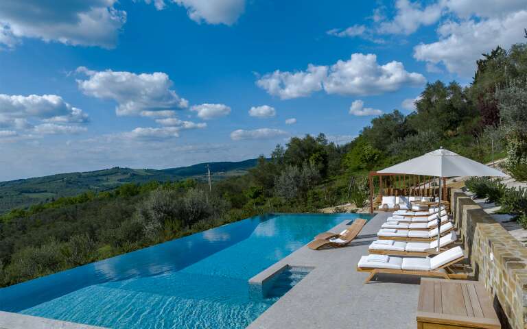 infinity swimming pool with sunbathing area