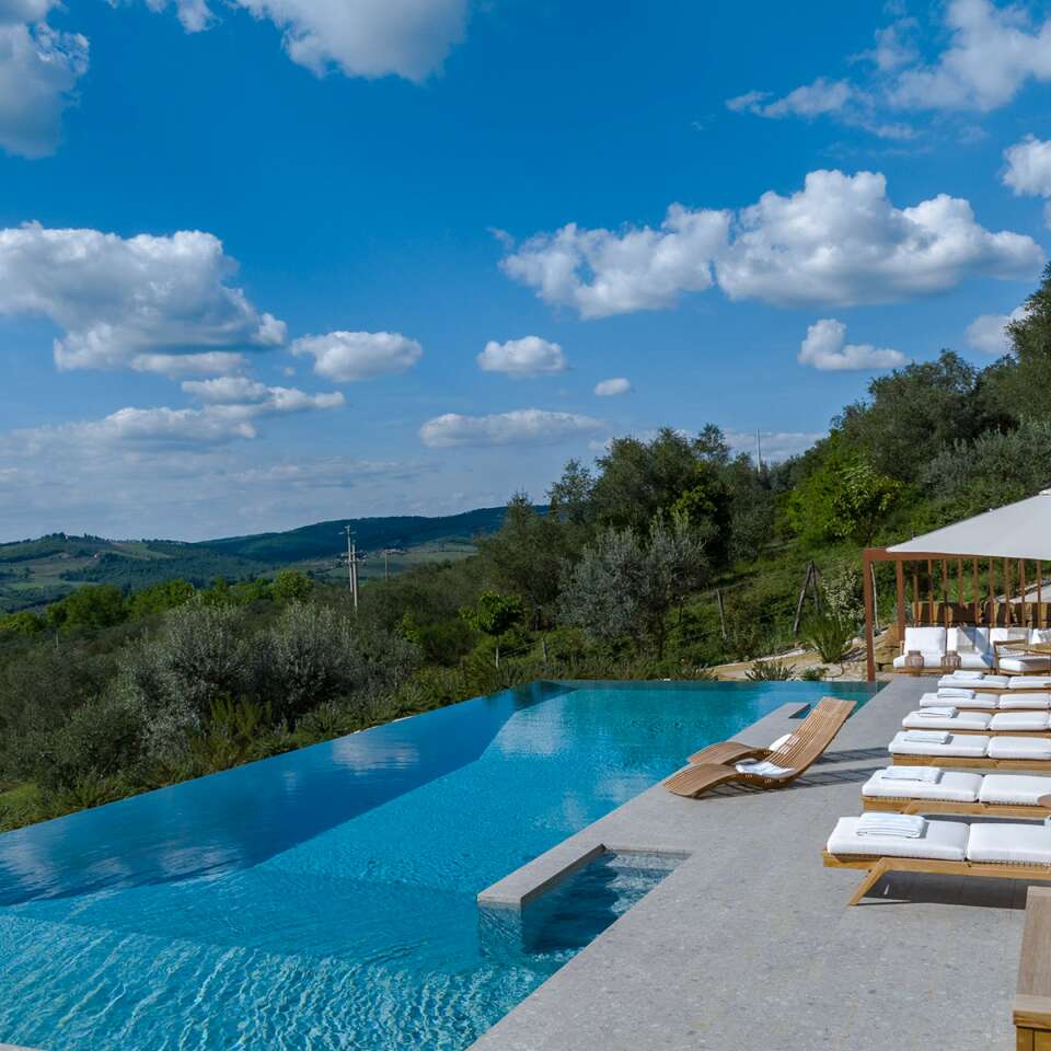 infinity swimming pool with sunbathing area