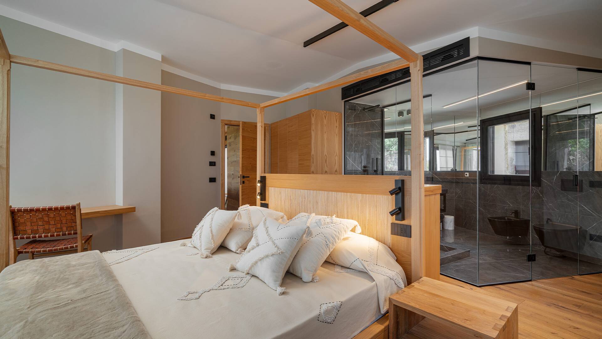 luxury double bedroom with en suite bathroom with glass walls