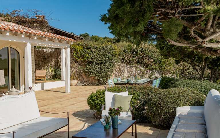 outdoor sitting area with sofas and coffee table