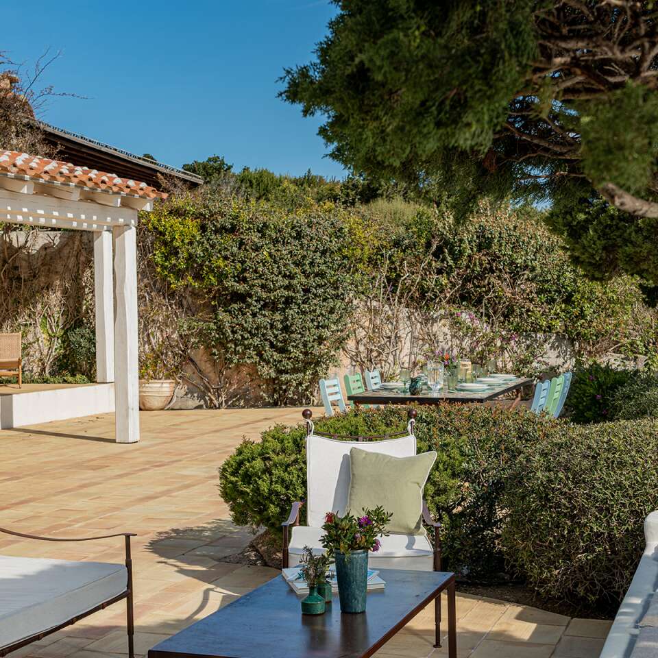 outdoor sitting area with sofas and coffee table
