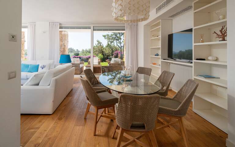 dining table and living room with TV