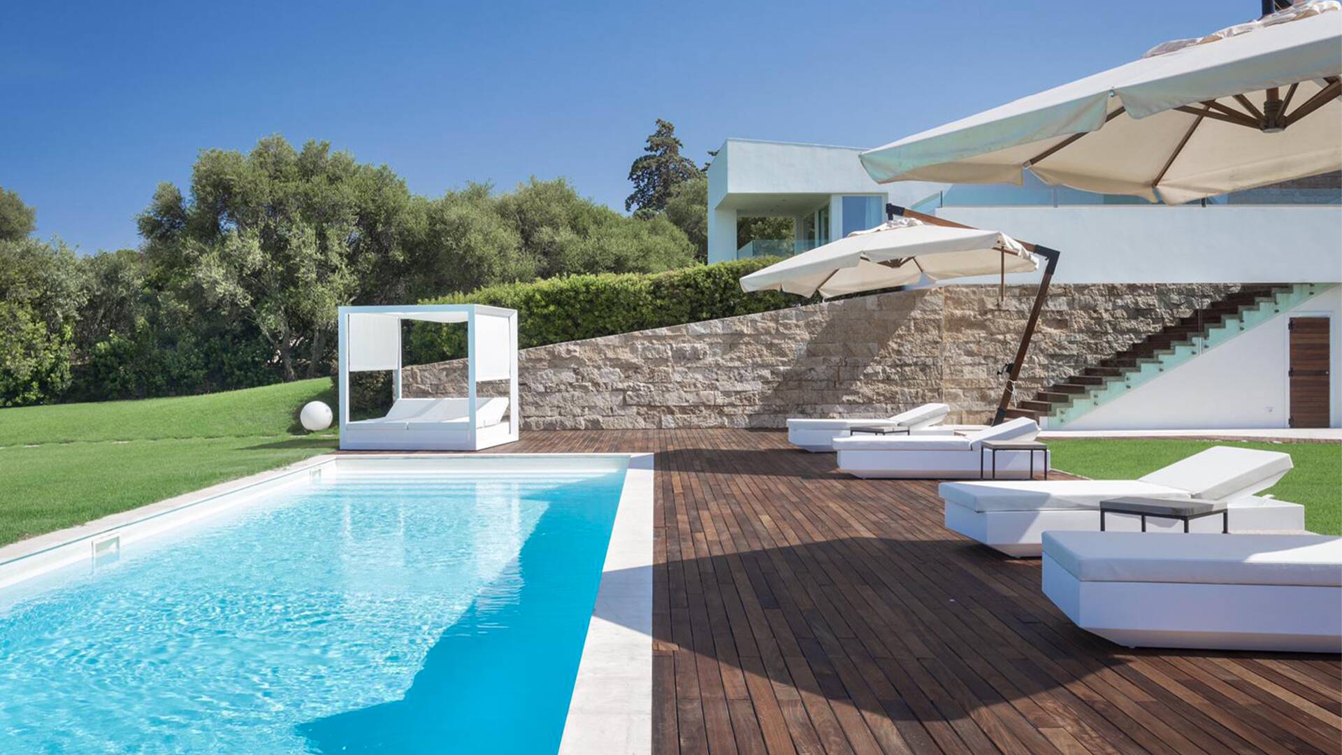 sunbathing area with gazebo and umbrellas