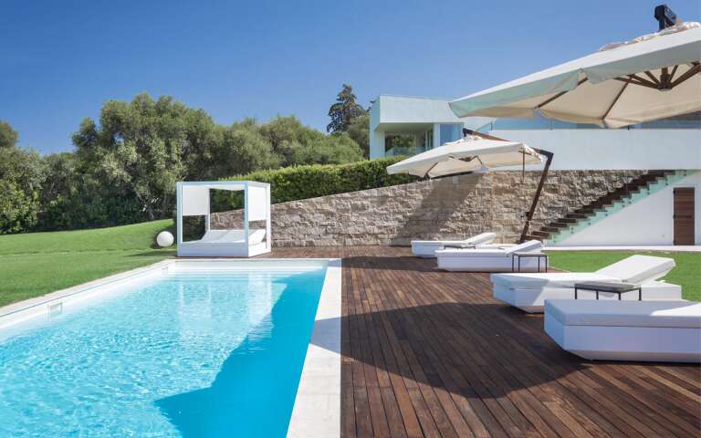 sunbathing area with gazebo and umbrellas