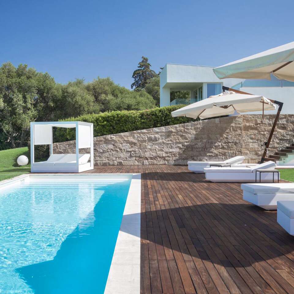 sunbathing area with gazebo and umbrellas