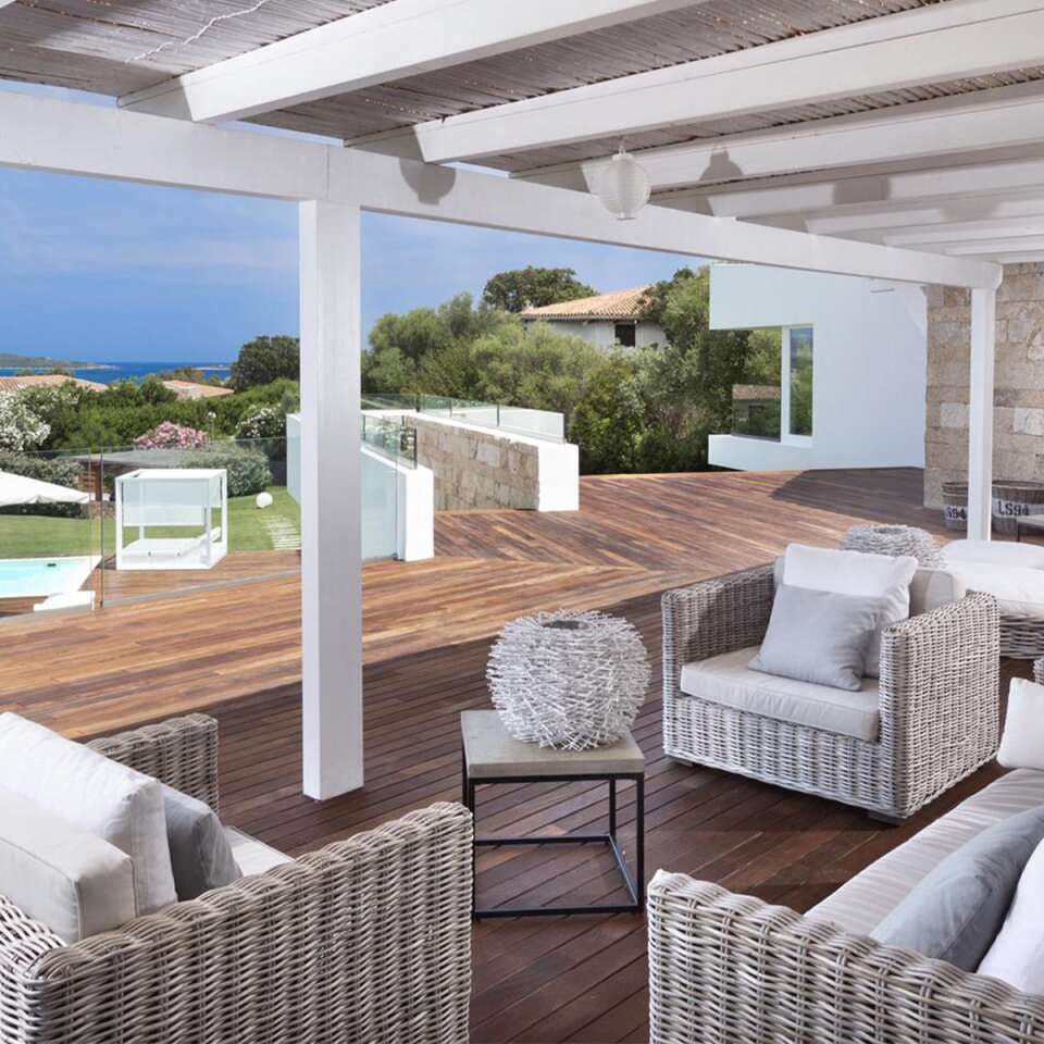 outdoor sitting area with pool and sea view