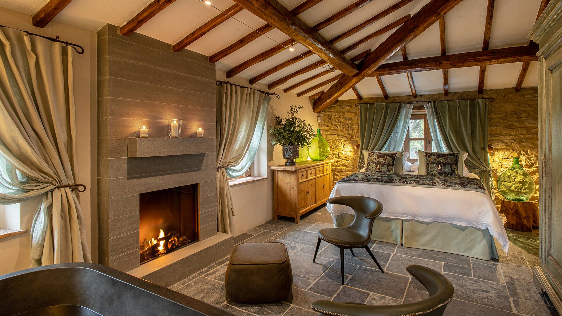 iconic double bedroom with fireplace and en suite bath tub