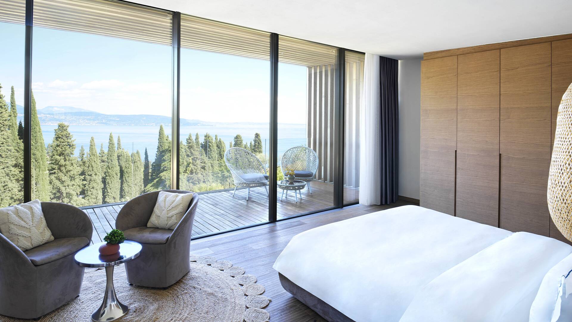luxury double bedroom with French windows and lake view