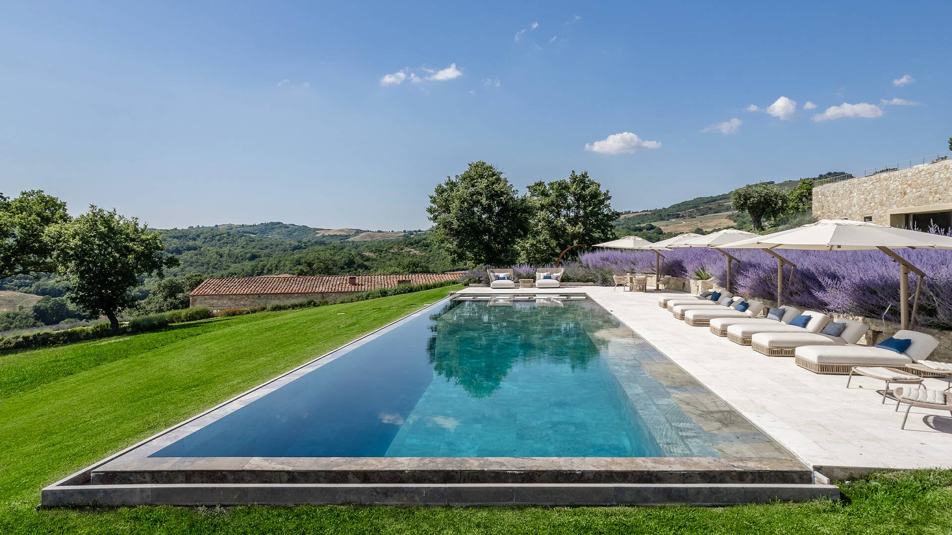 infinity swimming pool with travertine on the pool bottom