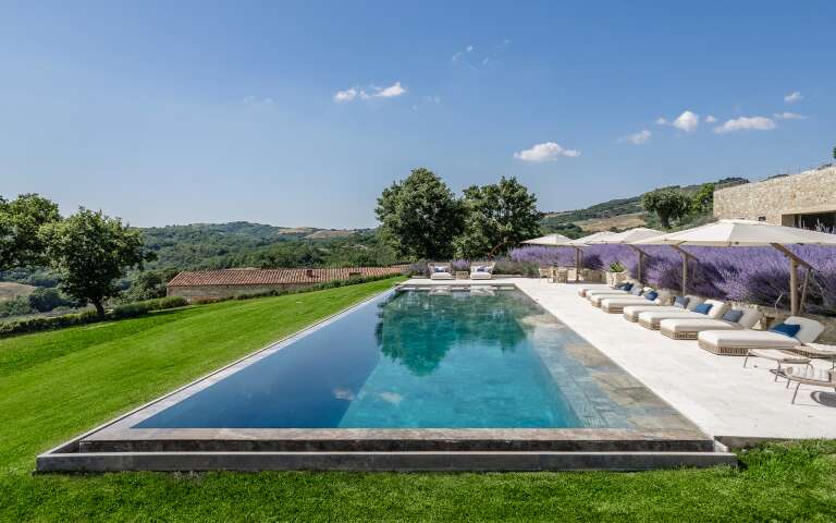 infinity swimming pool with travertine on the pool bottom