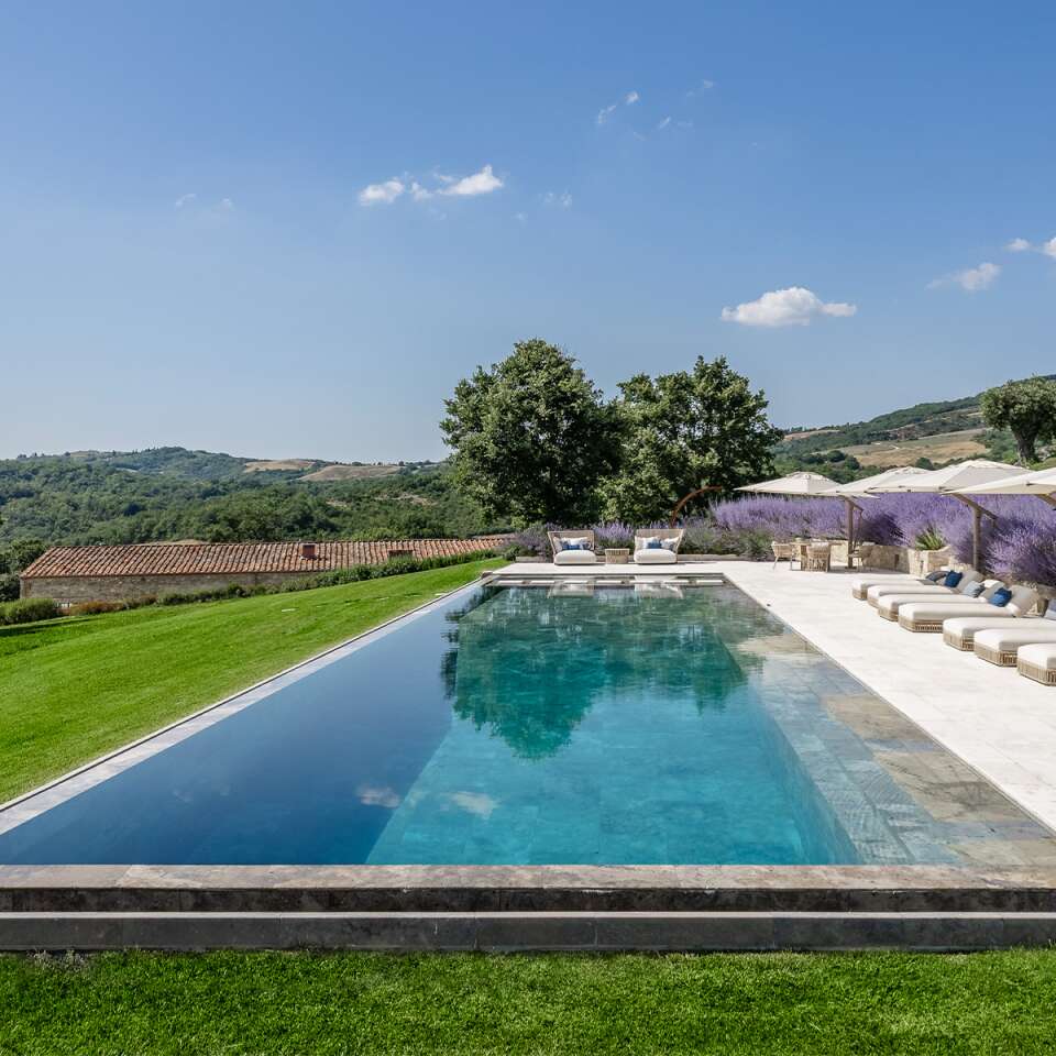 infinity swimming pool with travertine on the pool bottom