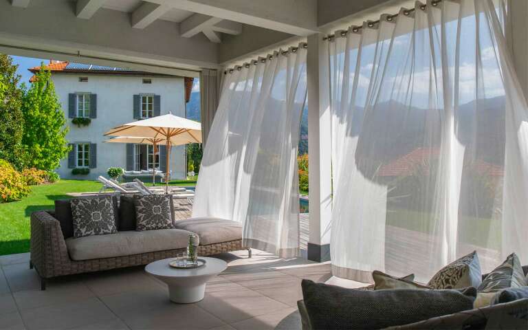 covered sitting area by private pool