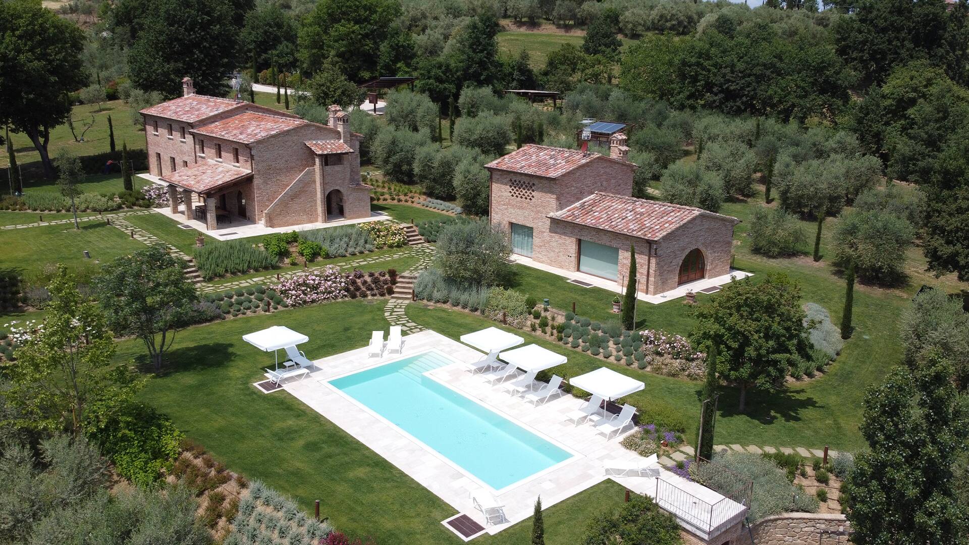 private swimming pool with sunbeds and umbrellas