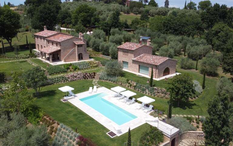 private swimming pool with sunbeds and umbrellas